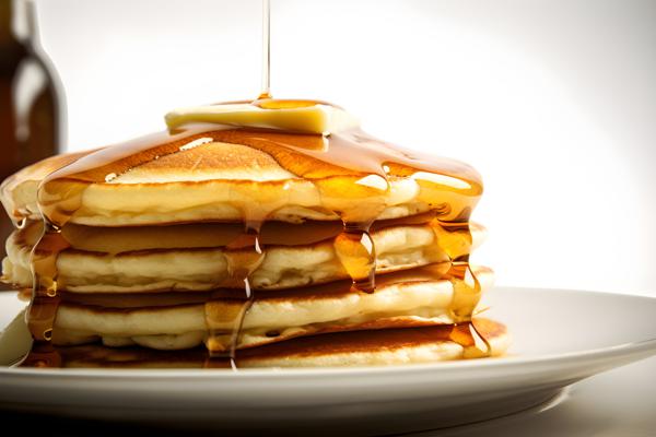 A stack of fluffy pancakes with maple syrup and butter, close-up, white background, realism, hd, 35mm photograph, sharp, sharpened, 8k