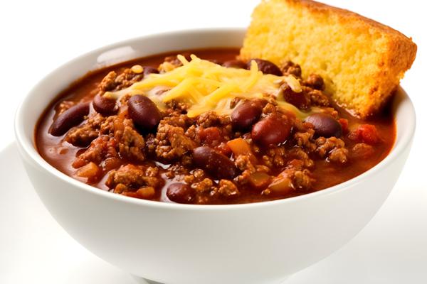 A bowl of hot chili with a side of cornbread, close-up, white background, realism, hd, 35mm photograph, sharp, sharpened, 8k